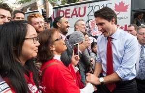 Liberal Leader Justin Trudeau greets supporters as he steps off his campaign bus for a rally Tuesday, October 13, 2015 in Toronto. THE CANADIAN PRESS/Paul Chiasson