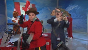 Late-night television personality John Oliver, right, and Canadian-born actor Mike Myers throw five thousand dollars of Canadian bills at the camera during a segment of an episode of Last Week Tonight, on Oct. 18, 2015, which dealt with the Canadian federal election. (The Canadian Press/HO-YouTube)