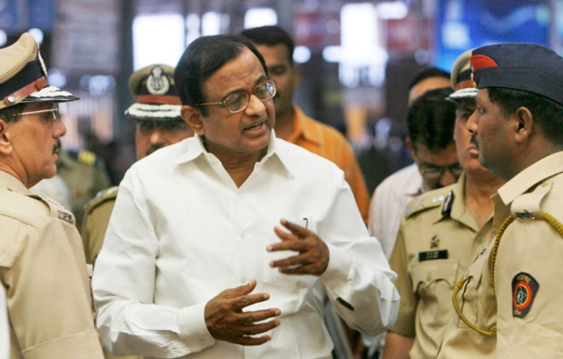 India's Home Minister Palaniappan Chidambaram, center, speaks with police officers and other officials during his visit to the Chhatrapati Shivaji terminus, one of the several places where the terrorists shot at people in Mumbai, India, Friday, Dec. 5, 2008. (AP / Gautam Singh)
