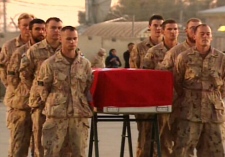 The remains of one of the three latest soldiers killed in Afghanistan are prepared to return to Canada on the tarmac at a ramp ceremony at Kandahar Airfield on Saturday, Dec. 6, 2008.
