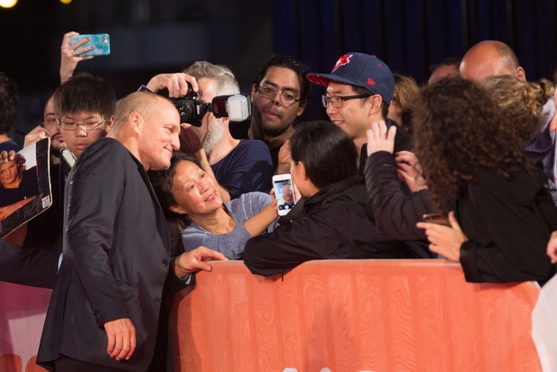 Actor Woody Harrelson mugs for fans as he arrives on the red carpet for the movie " The Edge of Seventeen" during the Toronto International Film Festival on Saturday, September 17, 2016. THE CANADIAN PRESS/Michelle Siu