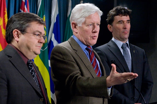 Liberal MP Bob Rae responds to a question as Bloc MP Paul Crete (left) and NDP MP Paul Dewar (right) listen to a question during a news conference on Parliament Hill in Ottawa, Canada Wednesday, Feb.11, 2009. (Adrian Wyld / THE CANADIAN PRESS)