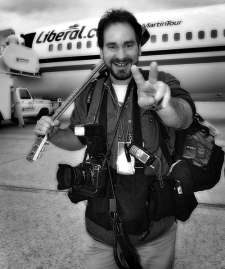 The Canadian Press news photographer Tom Hanson smiles by a Liberal campaign plane in this undated photo. (THE CANADIAN PRESS/Ottawa Sun-Tony Caldwell)