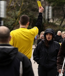 A man dressed as a soccer referee raises a yellow card to a pedestrian in downtown Vancouver, B.C., on Wednesday March 18, 2009, to promote the addition of the Vancouver Whitecaps soccer club to MLS. (THE CANADIAN PRESS/Darryl Dyck)