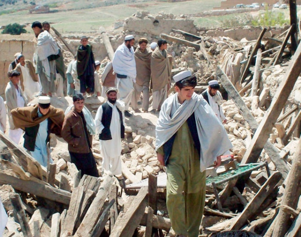 Afghan villagers walk on destroyed houses following two earthquakes in Sherzad district of Nangarhar province east of Kabul, Afghanistan, on Friday, April 17, 2009. (AP)