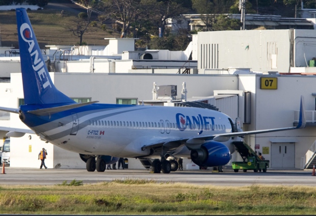 Soldiers stand near the hijacked Canjet 737 as it sits on the tarmac at the airport in Montego Bay, Jamaica, Monday, April 20, 2009. (Adrian Wyld / THE CANADIAN PRESS)