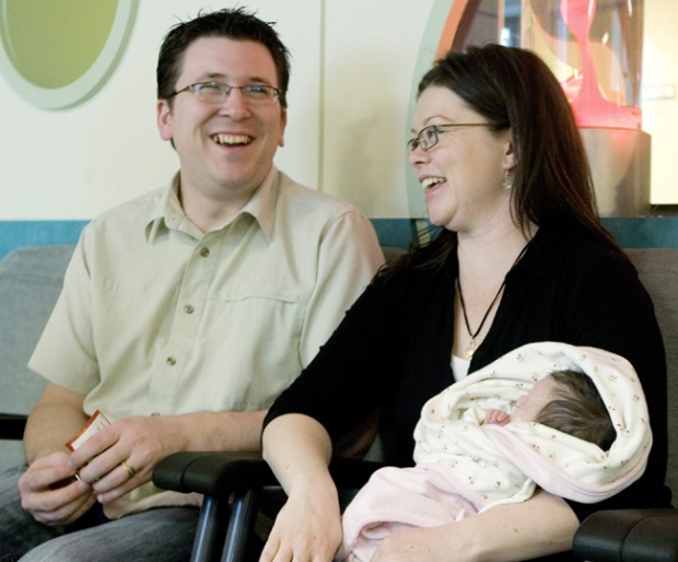 Newborn Oceane McKenzie is held by her mother Vicki who sits next to her husband Ian at Sick Kids Hospital in Toronto on Friday, May 8, 2009. (Chris Young / THE CANADIAN PRESS)