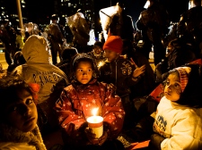 Children sit as police stand in front of Tamil demonstrators after the protestors successfully blocked the Gardiner Expressway in Toronto on Sunday, May 10, 2009. (THE CANADIAN PRESS/Nathan Denette)