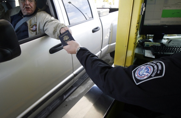 A driver hands his passport to a border agent at the Canada / U.S. border crossing in Highgate Springs, Vt., Monday, June 1, 2009. (AP / Toby Talbot)