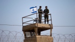In this Tuesday, May 15, 2018 file photo, Israeli soldiers guard on top of a watch tower in a community along the Israel-Gaza Strip Border. (AP Photo/Ariel Schalit, File)