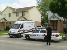 Police outside the London, Ont. home where the infants' bodies were found on Tuesday, June 9, 2009.