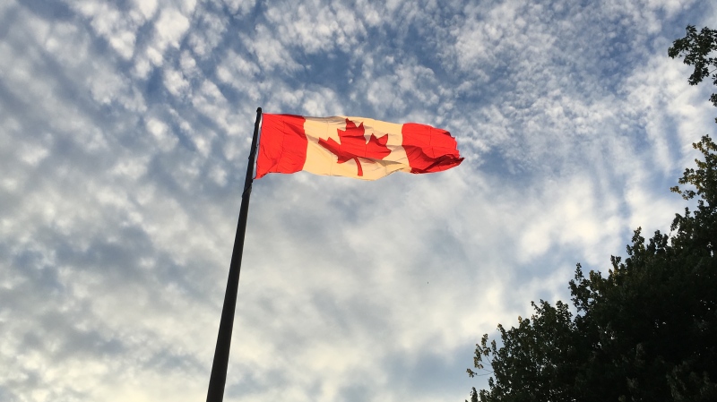 A Canadian flag blows in the wind at the Toronto waterfront. (Joshua Freeman /CP24)