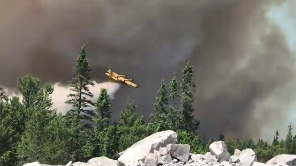 Waterbomber dumping water on fire