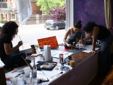 Mariana Jerez (left), Victoria Mata (centre), Liliana Chavez work on their pieces of art for the exhibit on June 19. 