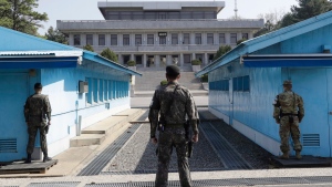 FILE - In this April 18, 2018 file photo, two South Korean soldiers, center and left, and U.S. soldier, right, stand in the southern side during a press tour at the border village of Panmunjom in the Demilitarized Zone, South Korea. (AP Photo/Lee Jin-man, File)