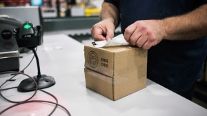 A worker applies a shipping label to a package of cannabis products at the Ontario Cannabis Store distribution centre in an undated handout photo. THE CANADIAN PRESS/HO-Ontario Cannabis Store