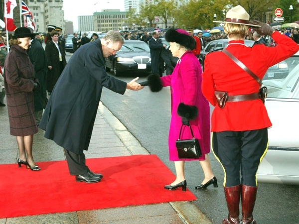 Queen Elizabeth II is greeted by Canadian Prime Minister Jean Chretien and his wife Aline as she arrives on Parliament Hill for an interfaith service, in Ottawa