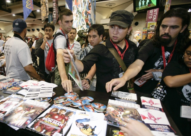 Fans grab for Ironman freebies at the Marvel Comics booth during the preview night for the Comic-Con International 2009 held in San Diego Wednesday, July 22, 2009. (AP / Denis Poroy)
