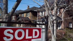 A sold sign is shown in front of west-end Toronto homes Sunday, April 9, 2017. (THE CANADIAN PRESS/Graeme Roy)