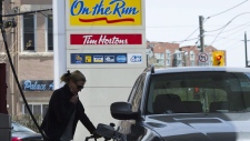 woman pumps gas