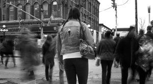 A woman stands on the sidewalk as people cross a street in this undated photo illustration. A national hotline to help victims and survivors of human trafficking is now taking calls, with the organization behind the initiative saying it hoped the service would also fill crucial gaps in public knowledge about the issue. THE CANADIAN PRESS/HO-Karen Joyner 