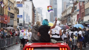 Toronto's Pride parade is set to take over the city's downtown core this weekend -- a rainbow-hued culmination of tensions that have simmered for months between some in the LGBTQ community and the organizers of the annual event. A reveller waves a modified Pride flag during the Toronto Pride parade on Sunday, June 24, 2018. THE CANADIAN PRESS/Cole Burston