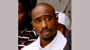 In this Aug. 15, 1996, file photo, rapper Tupac Shakur attends a voter registration event in South Central Los Angeles. (AP Photo/Frank Wiese, File)