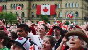 People take in the Canada 150 celebrations on Parliament Hill in Ottawa on Saturday, July 1, 2017. Ottawa is preparing for a hot, sunny Canada Day, with concerts, speeches and fireworks on Parliament Hill to mark the country's 152nd birthday. THE CANADIAN PRESS/ Sean Kilpatrick