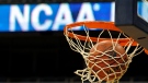 FILE - In this March 20, 2010, file photo, a ball flicks through the net in front of the NCAA logo on the marquis during an NCAA college basketball practice in Pittsburgh. (AP Photo/Keith Srakocic, File)