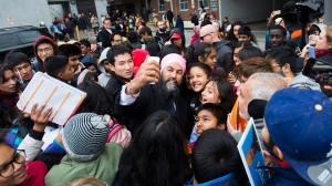 NDP leader Jagmeet Singh greets supporters and children in Toronto on Thursday, October 17, 2019. THE CANADIAN PRESS/Nathan Denette