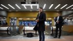 Prime Minister Justin Trudeau waits to greet commuters at a metro station in Montreal, Tuesday, Oct. 22, 2019. THE CANADIAN PRESS/Sean Kilpatrick