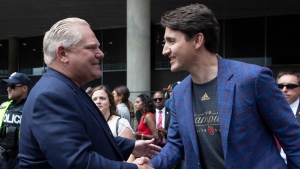 Prime Minister Justin Trudeau, right, shakes hands with Ontario Premier Doug Ford during the 2019 Toronto Raptors Championship parade in Toronto, on Monday, June 17, 2019. THE CANADIAN PRESS/Chris Young