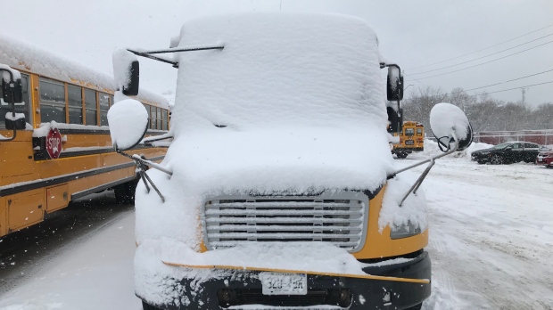School bus blanketed in snow
