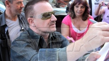 Bono from U2 signs autographs as he arrives at his hotel, Tuesday, Sept. 16, 2009. U2 will play sold-out shows tonight and tomorrow at the Rogers Centre. (Sean O'Neil for etalk)