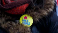 A button is seen as striking teachers of the Ontario Secondary School Teachers Federation picket outside of the Toronto District School Board head office on Yonge Street in Toronto, Wednesday, Dec. 4, 2019. THE CANADIAN PRESS/Cole Burston