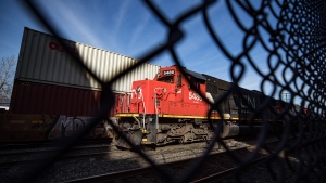 In this file photo, CN Rail locomotives are moved on tracks past cargo containers sitting on idle train cars at port in Vancouver, on Friday, February 21, 2020. THE CANADIAN PRESS/Darryl Dyck