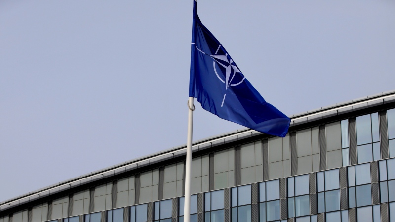 Flags of Alliance members flap in the wind outside NATO headquarters in Brussels, Friday, Feb. 28, 2020.  (AP Photo/Olivier Matthys)