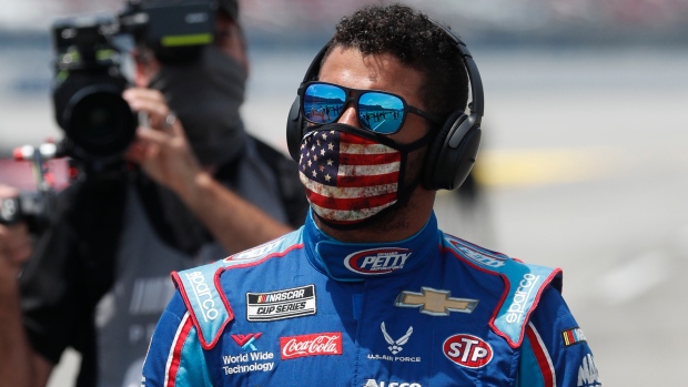 Driver Bubba Wallace walks to his car in the pits of the Talladega Superspeedway prior to the start of the NASCAR Cup Series auto race at the Talladega Superspeedway in Talladega Ala., Monday June 22, 2020. (AP Photo/John Bazemore)
