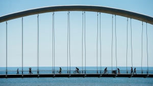 People get exercise in the warm weather as they cross the Humber Bay bridge in Toronto on Tuesday, June 9, 2020. THE CANADIAN PRESS/Nathan Denette