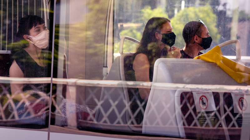 Toronto Transit Commission riders wear masks as they ride a streetcar in Toronto on Thursday, July 2, 2020. THE CANADIAN PRESS/Frank Gunn