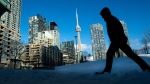 Condo towers dot the Toronto skyline as a pedestrian makes his way through the COVID-19 restricted winter landscape on Thursday January 28, 2021. CMHC says that rental vacancies are up in Canada’s largest cities with rents rising too. THE CANADIAN PRESS/Frank Gunn