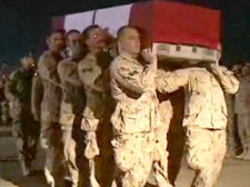 The casket of Sapper Steven Marshall is carried towards a plane during a ramp ceremony at Kandahar Airfield in Afghanistan, on Saturday, Oct. 31, 2009.