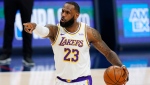 Los Angeles Lakers forward LeBron James gestures to teammates during the second half of an NBA basketball game against the Denver Nuggets on Sunday, Feb. 14, 2021, in Denver. (AP Photo/David Zalubowski)