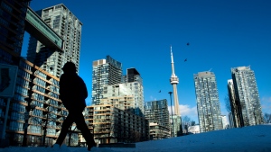 Condo towers dot the Toronto skyline as a pedestrian makes his way through the COVID-19 restricted winter landscape on Thursday January 28, 2021. THE CANADIAN PRESS/Frank Gunn