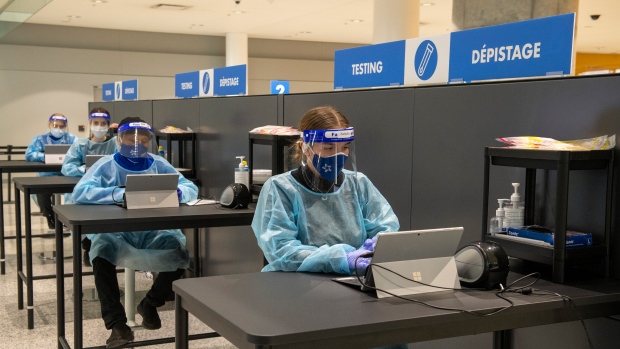 Workers prepare to greet passengers at the COVID-19 testing centre in the International Arrivals area at Pearson Airport in Toronto on Tuesday January 26, 2021. THE CANADIAN PRESS/Frank Gunn