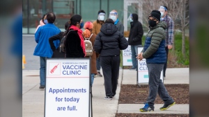 Visitors arrive at a pop up COVID-19 vaccine clinic at David and Mary Thomson high school in Toronto on Thursday, April 29, 2021. Hundreds of people lined up through the night in the hard hit community. THE CANADIAN PRESS/Frank Gunn