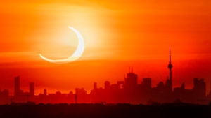 An annular solar eclipse rises over the skyline of Toronto on Thursday, June 10, 2021. THE CANADIAN PRESS/Frank Gunn 