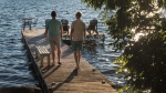 Chris Van Lierop, left, and Tim Wisener are seen at their cottage home on Sturgeon Lake near Fenelon Falls, Ont., on Wednesday, July 18, 2018. THE CANADIAN PRESS/Fred Thornhill 