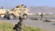 U.S soldiers stand guard along a perimeter at the international airport in Kabul, Afghanistan, Monday, Aug. 16, 2021. (AP Photo/Shekib Rahmani) 