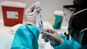 In this July 22, 2021, file photo, health care worker fills a syringe with the Pfizer COVID-19 vaccine at the American Museum of Natural History in New York. (AP Photo/Mary Altaffer, File)